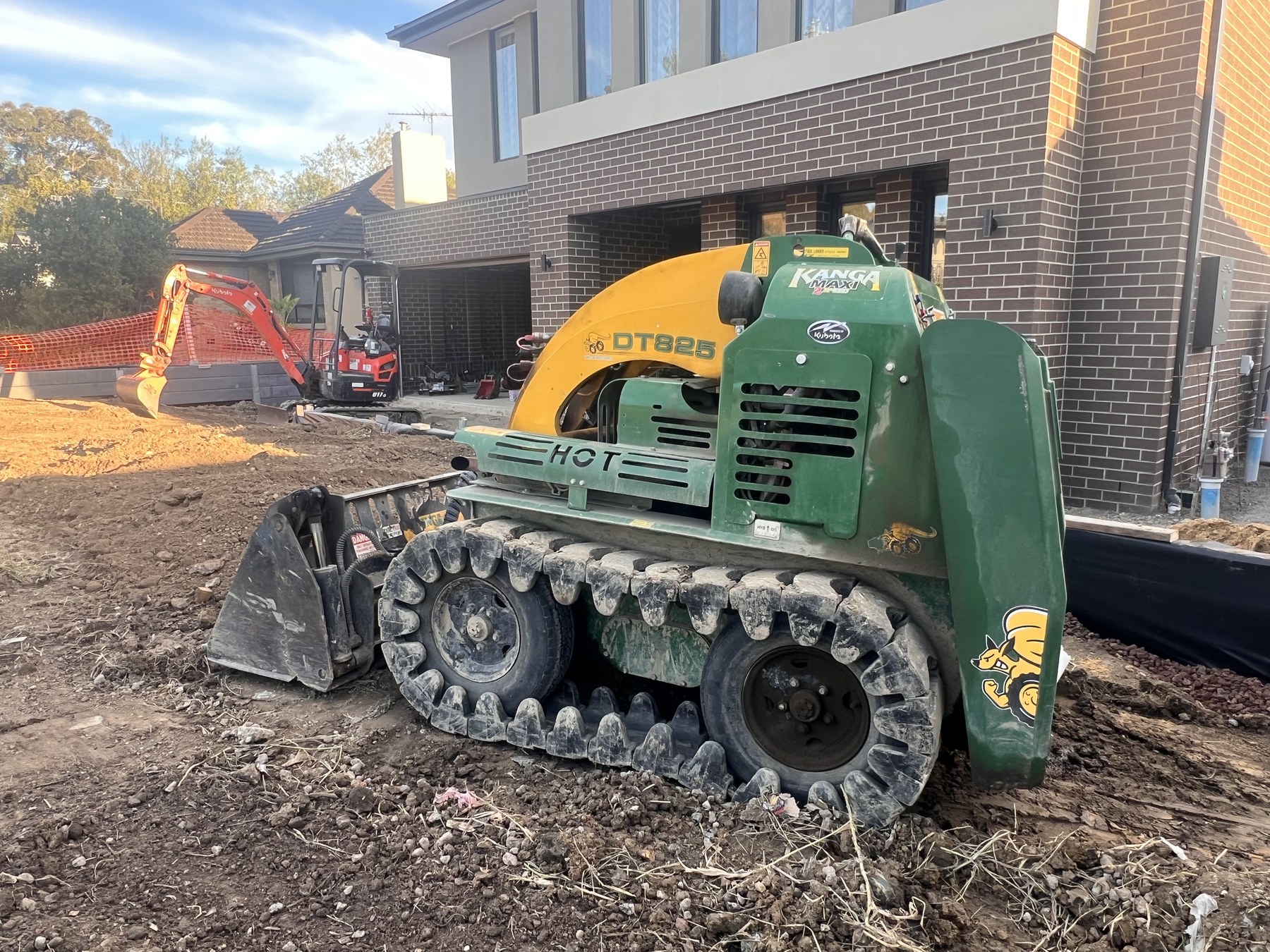 Compact loader preparing a front yard site